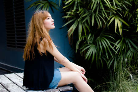 Beautiful young adult thai chinese bronze hair relax and smile