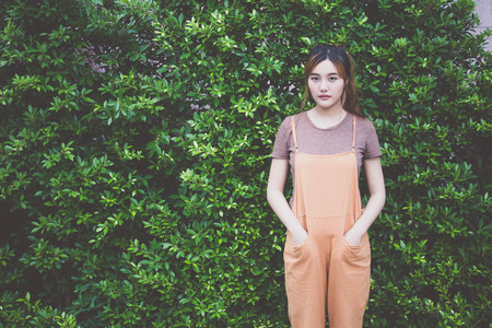Beautiful young adult thai chinese bronze hair relax and smile