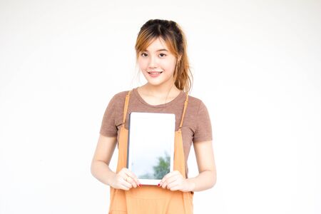 Beautiful young adult thai chinese bronze hair show her tablet.の写真素材