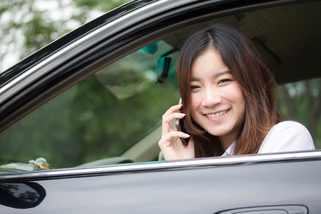 thai adult working women white shirt talking phone near in carの写真素材