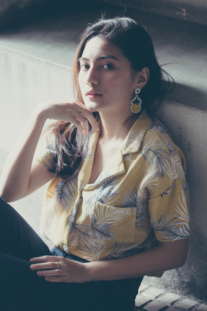 Portrait of thai yellow shirt adult beautiful girl relax time, in Vintage Styleの写真素材