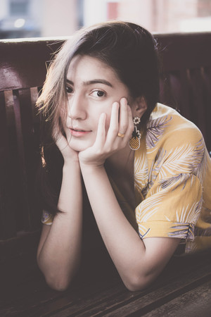 Portrait of thai yellow shirt adult beautiful girl relax time, in Vintage Styleの写真素材