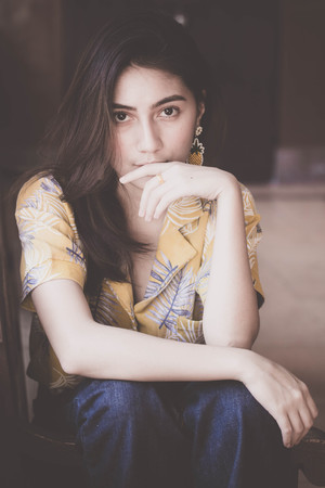 Portrait of thai yellow shirt adult beautiful girl relax time, in Vintage Styleの写真素材