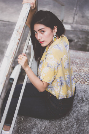 Portrait of thai yellow shirt adult beautiful girl relax time, in Vintage Styleの写真素材