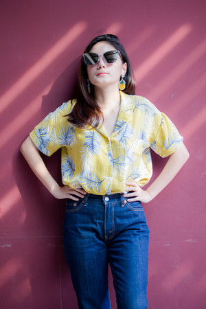 Portrait of thai yellow shirt adult beautiful girl relax and smile
