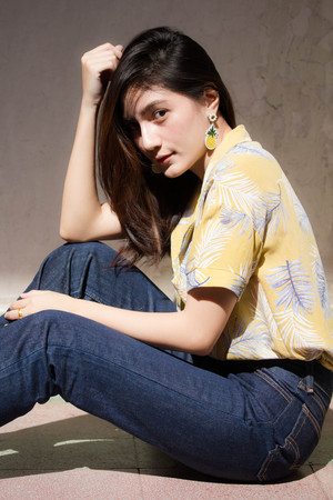 Portrait of thai yellow shirt adult beautiful girl relax and smile