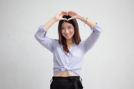 Portrait of thai adult beautiful girl give heartの写真素材