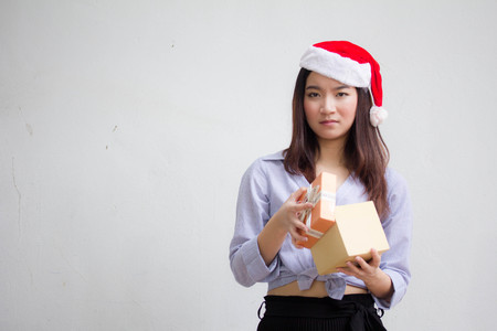 Portrait of thai adult beautiful girl hold gift box in handsの写真素材