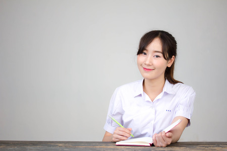 asia thai high school student uniform beautiful girl Write a bookの写真素材