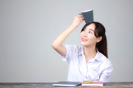 asia thai high school student uniform beautiful girl drinking coffeeの写真素材