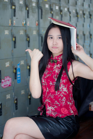 Portrait of thai teen beautiful girl in Chinese dress read a book.の写真素材