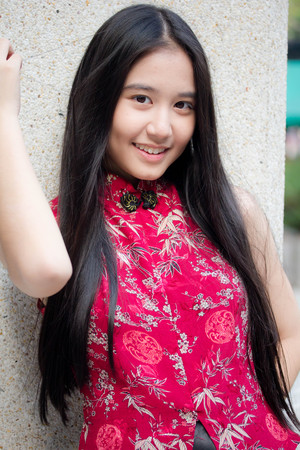 Portrait of thai teen beautiful girl in Chinese dress, relax and smile.の写真素材