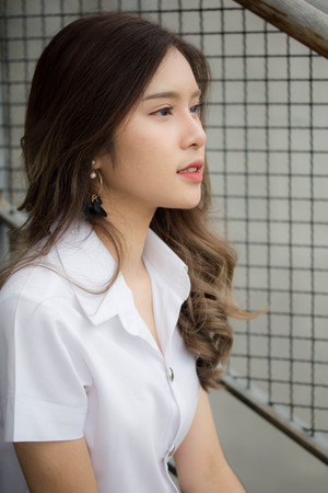 Portrait of thai adult student university uniform beautiful girl relax and smile