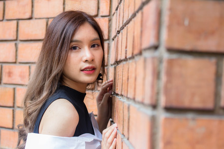 Portrait of thai Jeans skirt white shirt adult beautiful girl relax and smileの写真素材