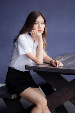 Portrait of thai adult student university uniform beautiful girl relax and smileの写真素材