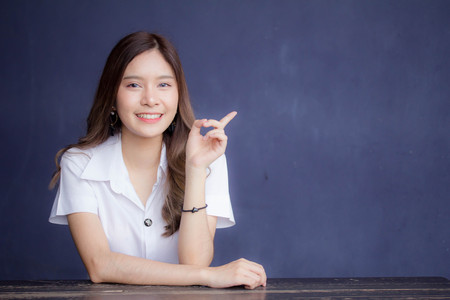 Portrait of thai adult student university uniform beautiful girl relax and smileの写真素材