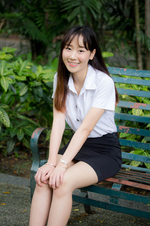 Portrait of thai adult student university uniform beautiful girl relax and smileの写真素材