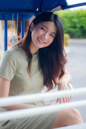Portrait of thai china adult beautiful girl Green dress blue jeans relax and smileの写真素材