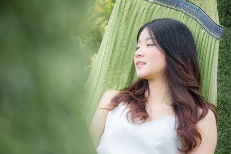 Portrait of thai china adult beautiful girl White shirt blue jeans relax and smileの写真素材
