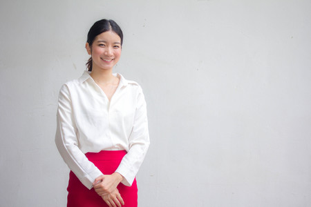Portrait of thai adult working women white shirt red skirt relax and smile
