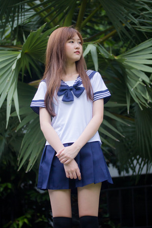 Portrait of thai teen beautiful girl in japanese student uniform happy and relax