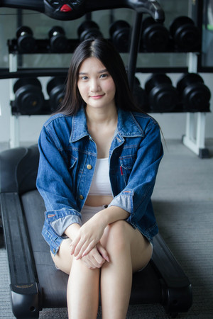Portrait of thai adult beautiful girl blue jeans relax and smileの写真素材