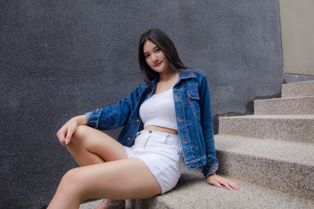 Portrait of thai adult beautiful girl blue jeans in fitness relax and smile