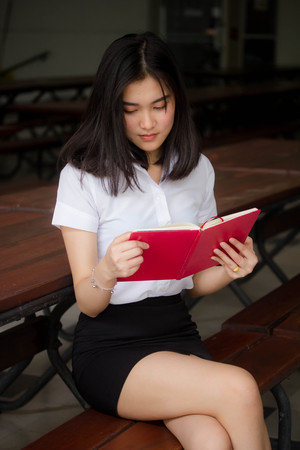 Portrait of thai adult student university uniform beautiful girl relax and smileの写真素材