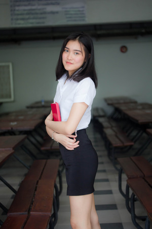 Portrait of thai adult student university uniform beautiful girl relax and smileの写真素材