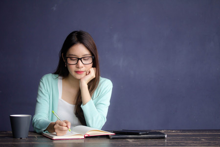 thai china adult office girl glasses white shirt Write bookの写真素材