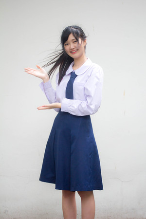 Portrait of thai high school student uniform beautiful girl pointingの写真素材