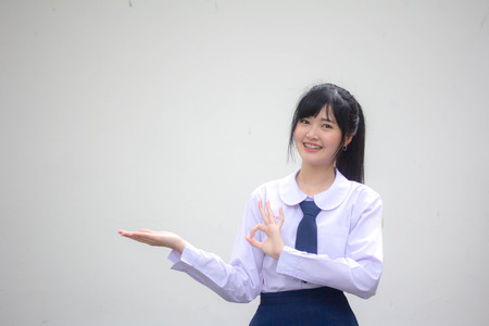 Portrait of thai high school student uniform beautiful girl show handの写真素材