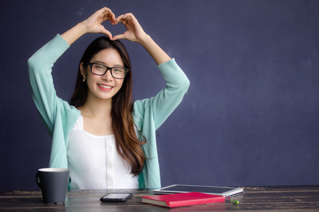thai china adult office girl glasses give heartの写真素材