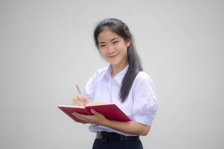 asia thai high school student uniform beautiful girl Write a bookの写真素材