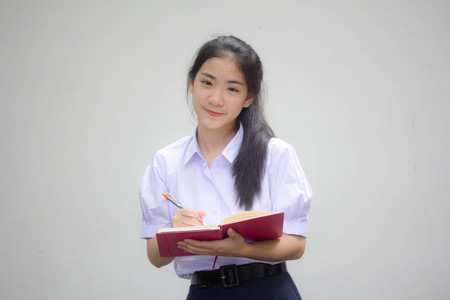 asia thai high school student uniform beautiful girl Write a bookの写真素材