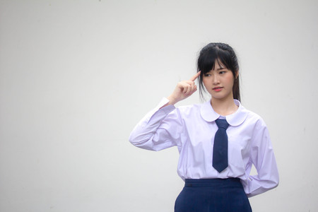 Portrait of thai high school student uniform beautiful girl Thinkの写真素材