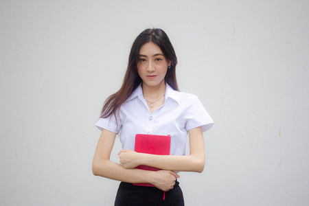 Portrait of thai adult student university uniform beautiful girl relax and smileの写真素材