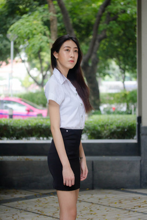 Portrait of thai adult student university uniform beautiful girl relax and smileの写真素材