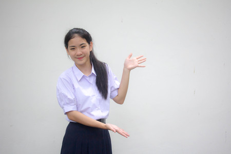 Portrait of thai high school student uniform beautiful girl show handの写真素材