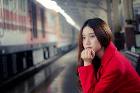asia thai teen red coat in train stationの写真素材