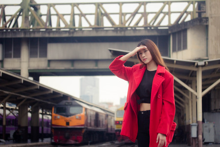asia thai teen red coat in train stationの写真素材