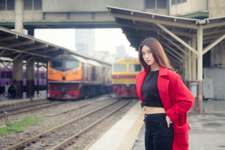 asia thai teen red coat in train stationの写真素材