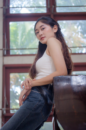 Portrait of thai china adult beautiful girl White shirt blue jeans relax and smile