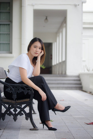 portrait of thai china adult office girl white shirt relax and smileの写真素材