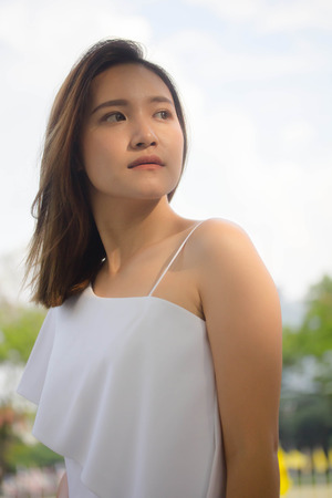 portrait of thai china adult office girl white shirt relax and smileの写真素材