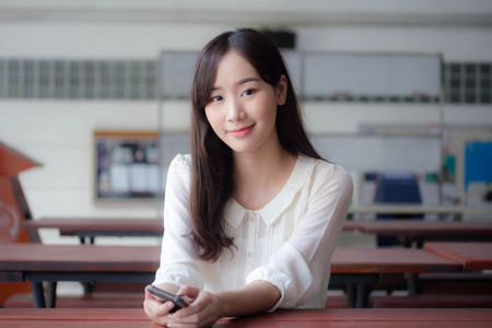 portrait of thai china adult office girl white shirt relax and smileの写真素材