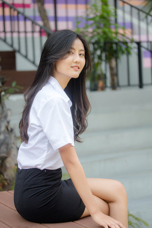 Portrait of thai adult student university uniform beautiful girl relax and smileの写真素材