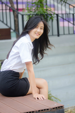 Portrait of thai adult student university uniform beautiful girl relax and smileの写真素材