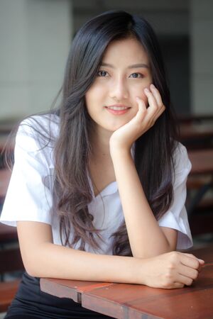Portrait of thai adult student university uniform beautiful girl relax and smile