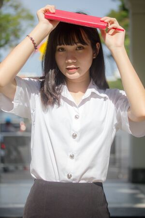 Portrait of thai adult student university uniform beautiful girl relax and smileの写真素材